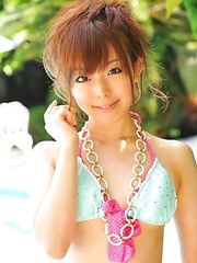 Asian girls pose in bikinis outside