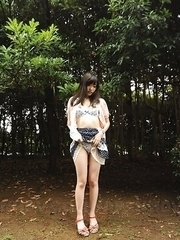Riko Tabe shows boobs and trimmed pussy under skirt in a park.