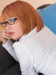Glasses-wearing secretary Chie Kobayashi flashing her pussy on a couch
